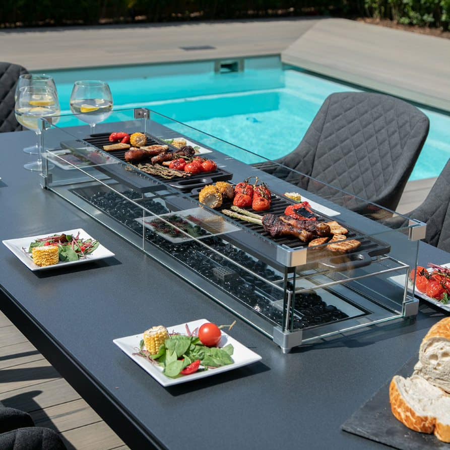 Close up of a fire pit dining table with charcoal fabric dining chairs #colour_charcoal