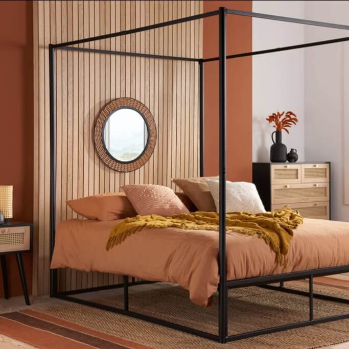 Black metal frame four poster bed.