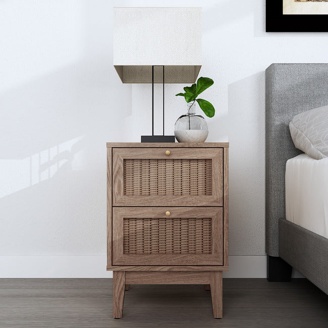 Oak coloured 2 drawer bedside table with rattan fronts and gold handles.