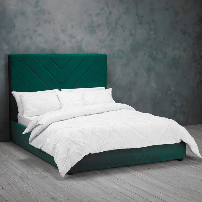 Green velvet bed frame with v shape stitched detail headboard.