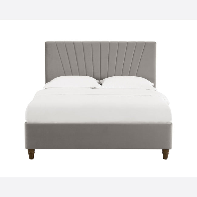 Front view of a grey velvet bed frame with stitched detail headboard.