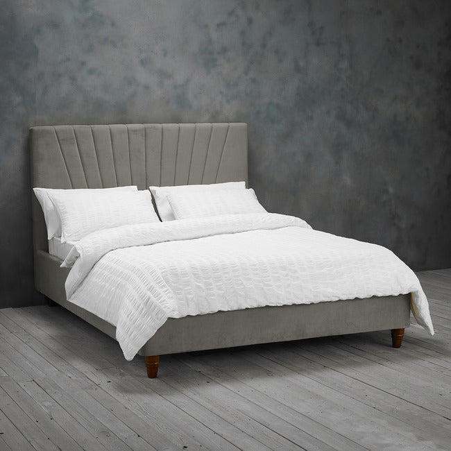 Grey velvet bed frame with stitched detail headboard.