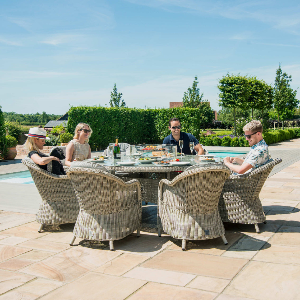 Light grey coloured rattan 8 seat round dining set with fire pit table
