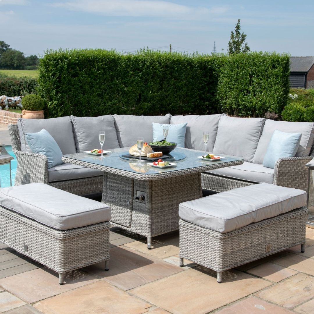 Light grey coloured rattan corner sofa with two matching benches and square fire pit table.