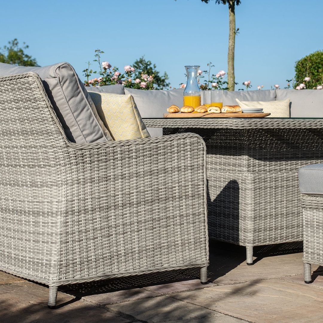 Light grey coloured rattan u shape sofa with matching bench and square rising table.