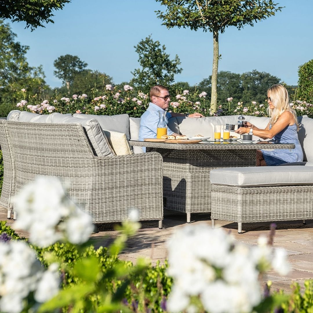 Light grey coloured rattan u shape sofa with matching bench and square rising table.