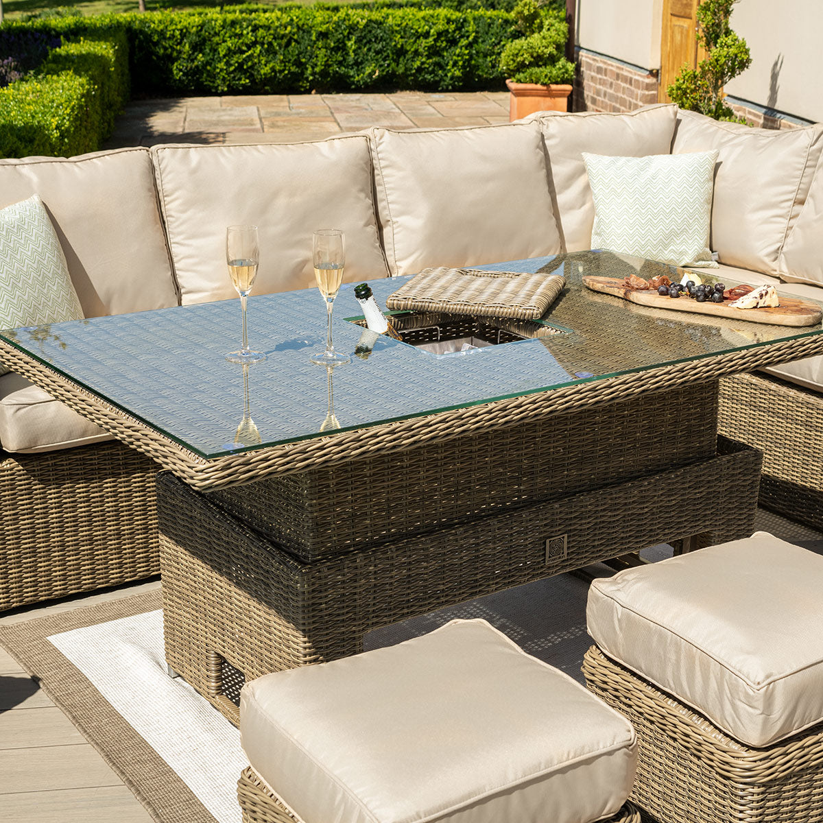 Close up of a natural coloured rattan rectangle rising table with ice bucket.