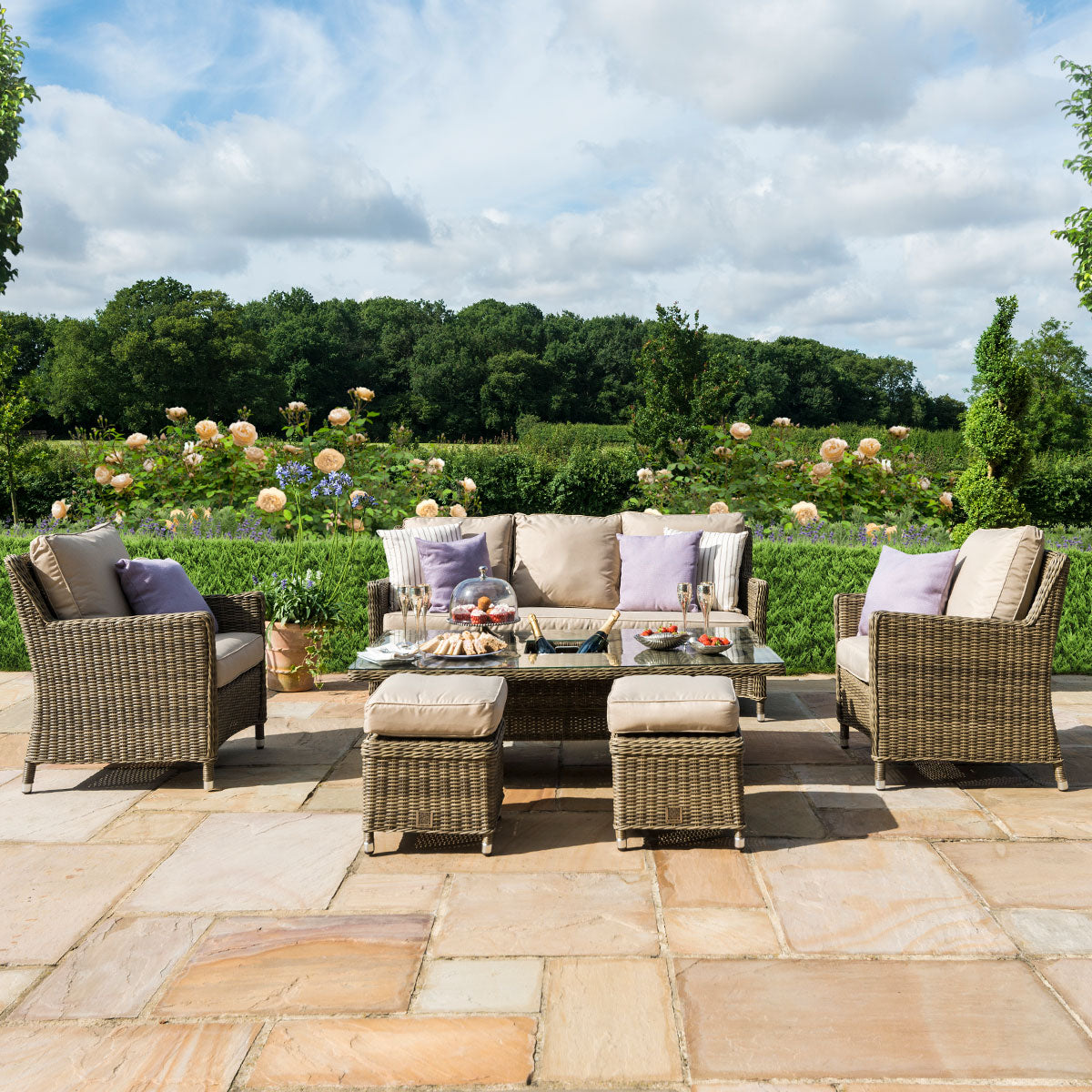 Brown coloured rattan 3 seat sofa dining set with two armchairs, two stools and a rectangle ice bucket rising table.
