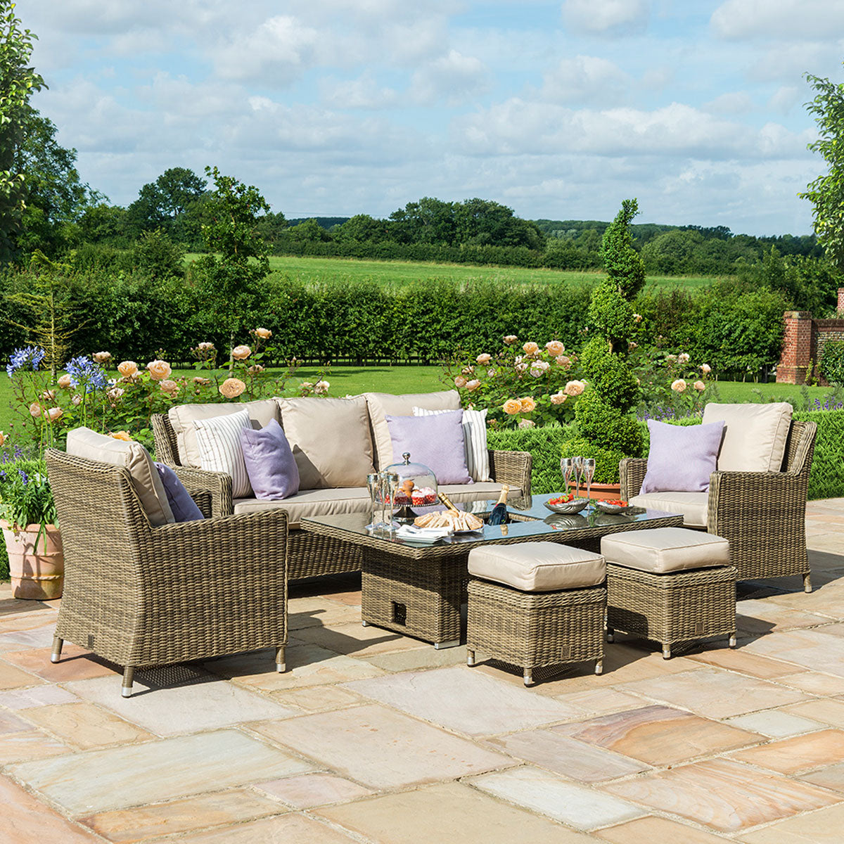 Brown coloured rattan 3 seat sofa dining set with two armchairs, two stools and a rectangle ice bucket rising table.