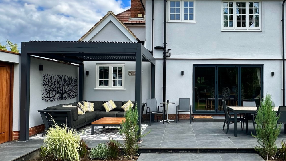Aluminium pergola with a corner sofa underneath