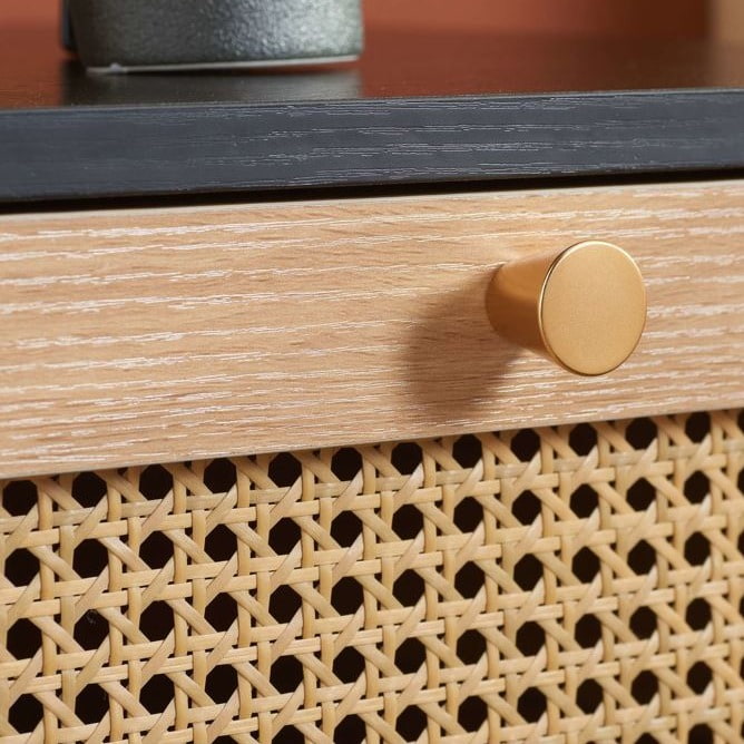 Close up of a rattan drawer front and handle.