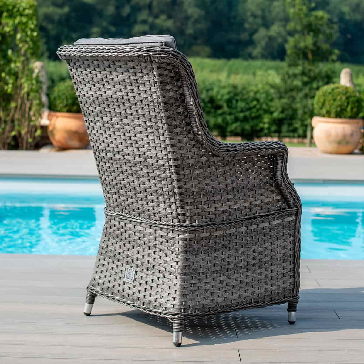 Close up of a grey rattan high back dining chair