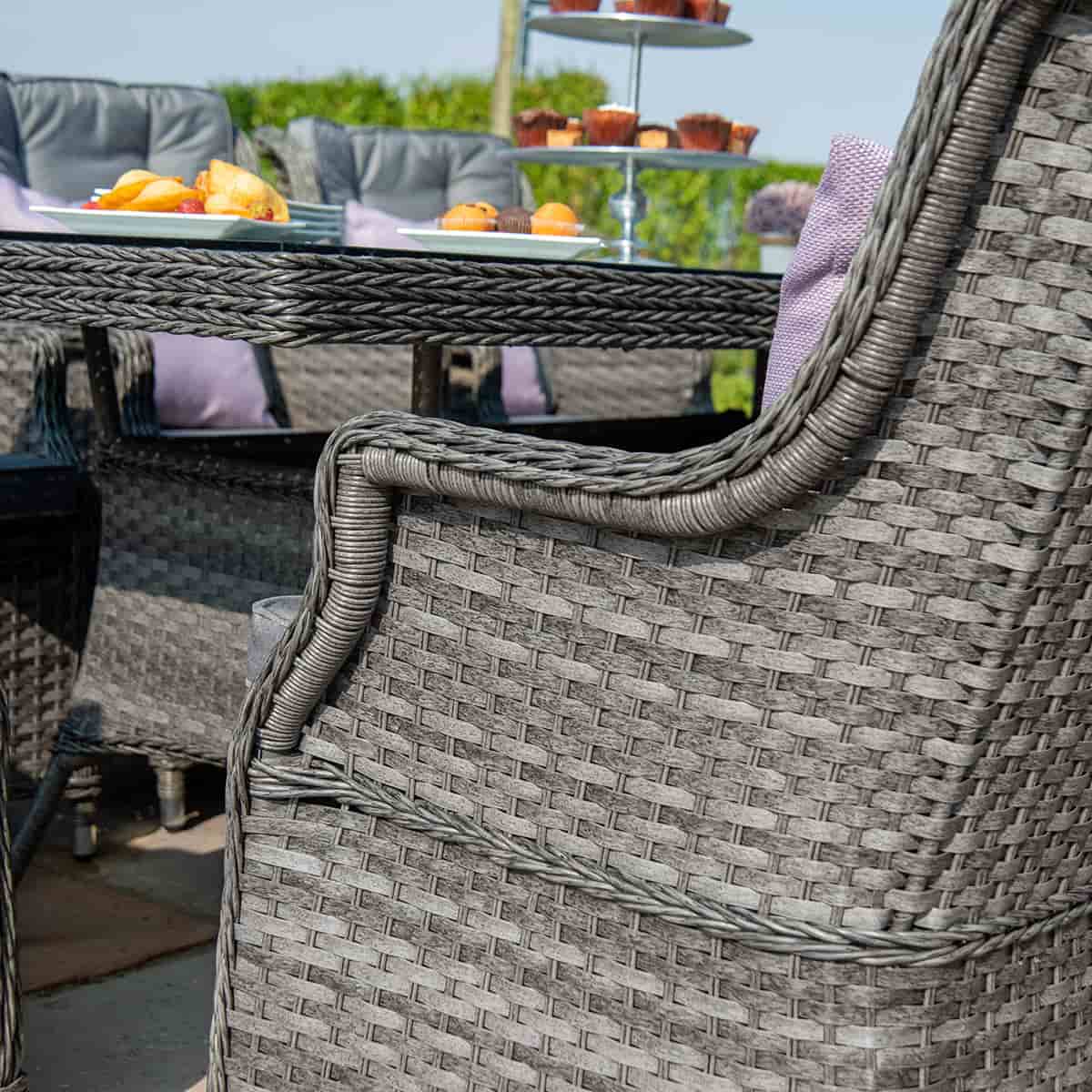 Close up of a grey rattan high back dining chair