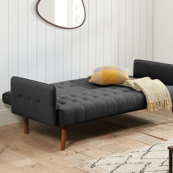 Charcoal fabric sofa bed with wooden legs, shown as a bed with back rest down.