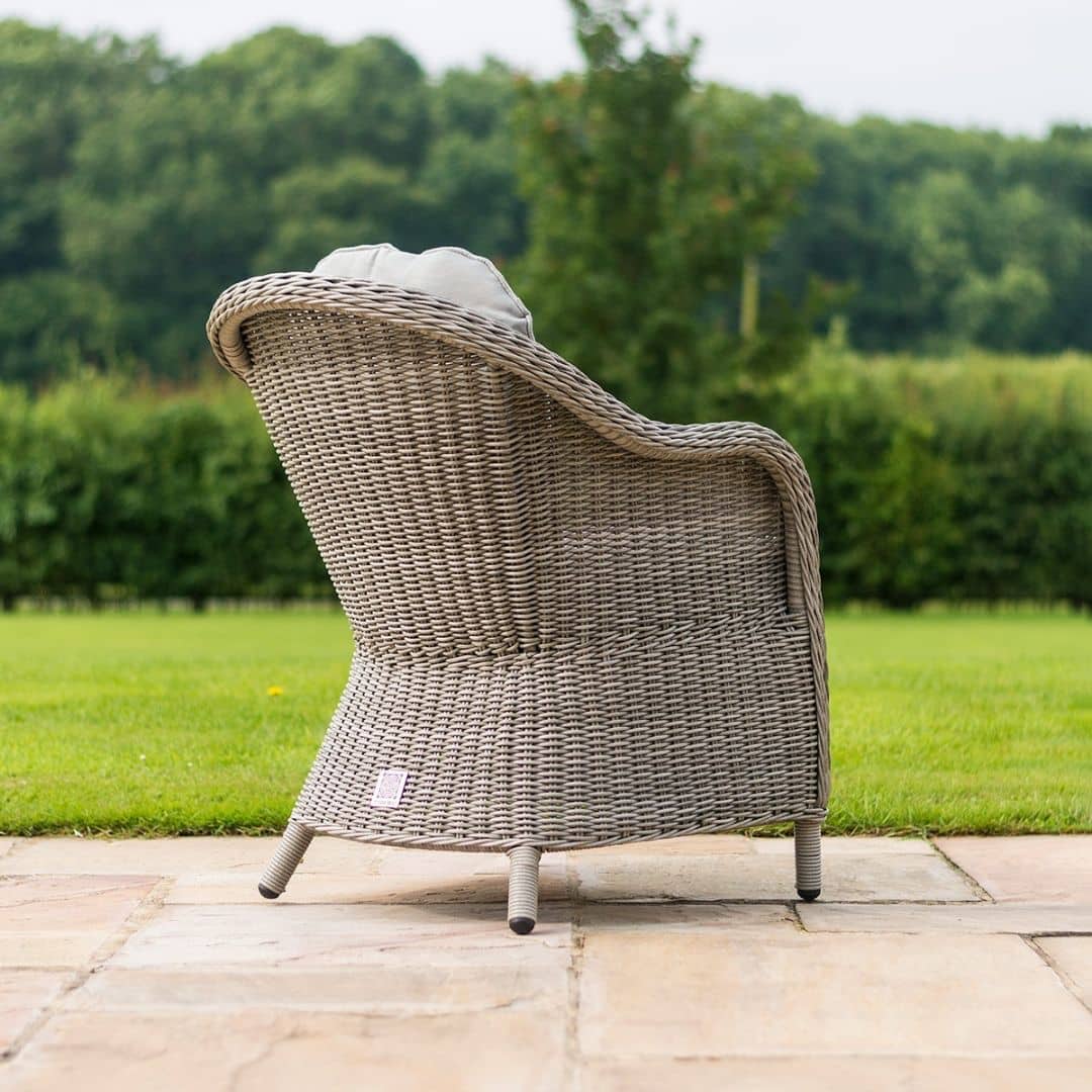 Close up of a light grey rattan dining chair