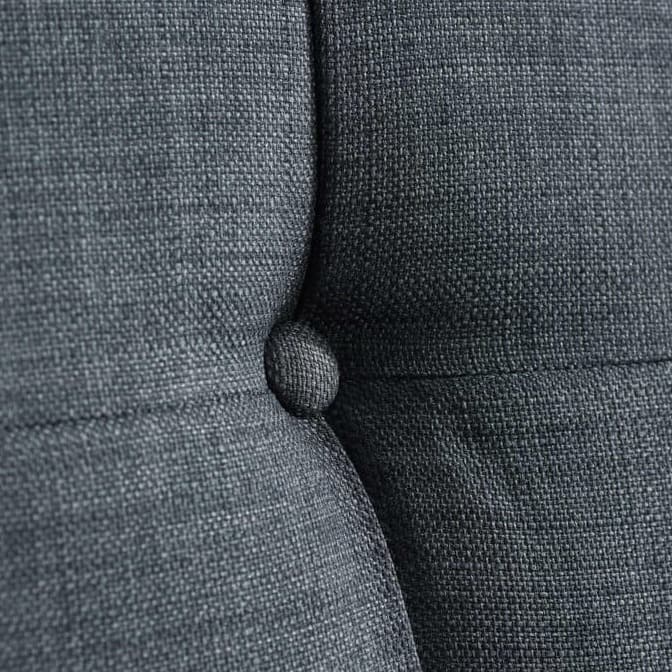 Close up of a grey sofa bed backrest button detail