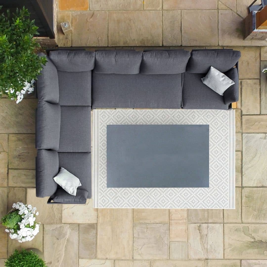 Overhead view of aluminium corner sofa with rectangular rising table #colour_charcoal