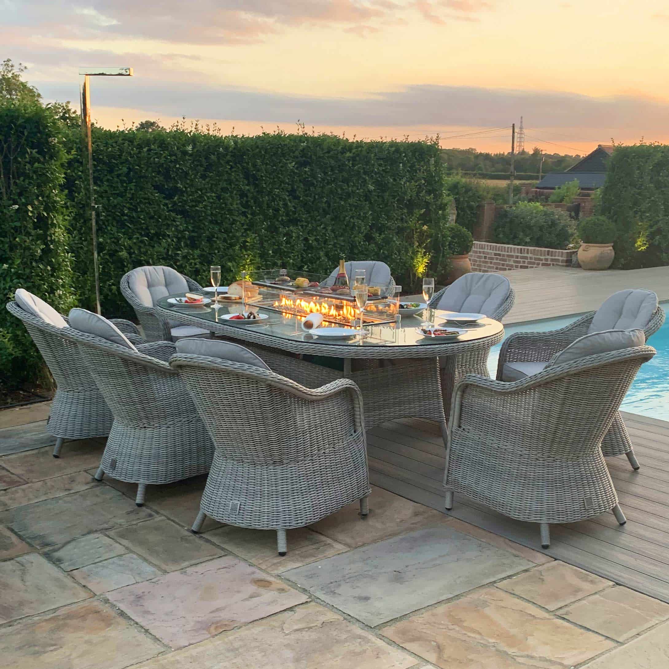 Light grey rattan 8 seat oval fire pit dining set with heritage chairs