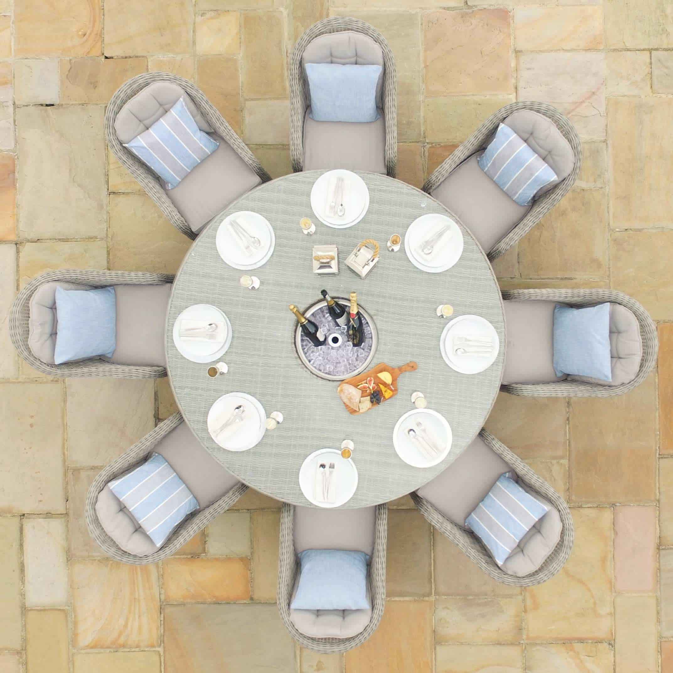 Overhead view of a light grey rattan 8 seat round ice bucket dining set with heritage chairs