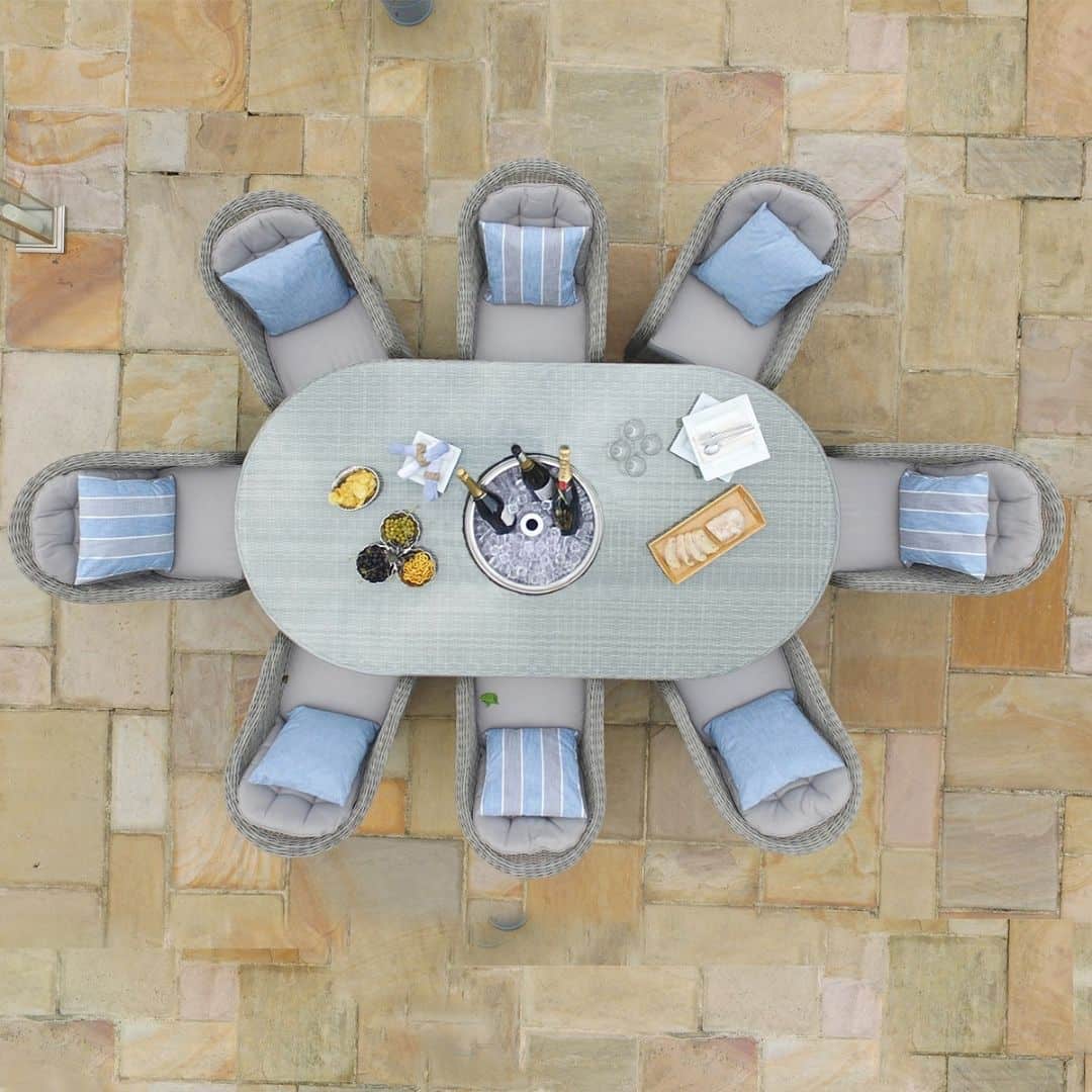 Overhead view of a light grey rattan 8 seat oval ice bucket dining set with heritage chairs