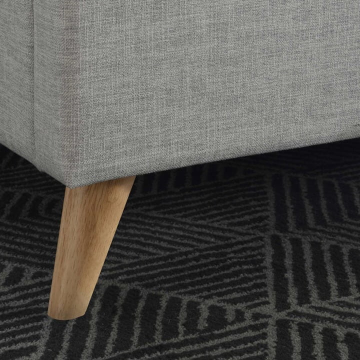Close up of a grey fabric bed