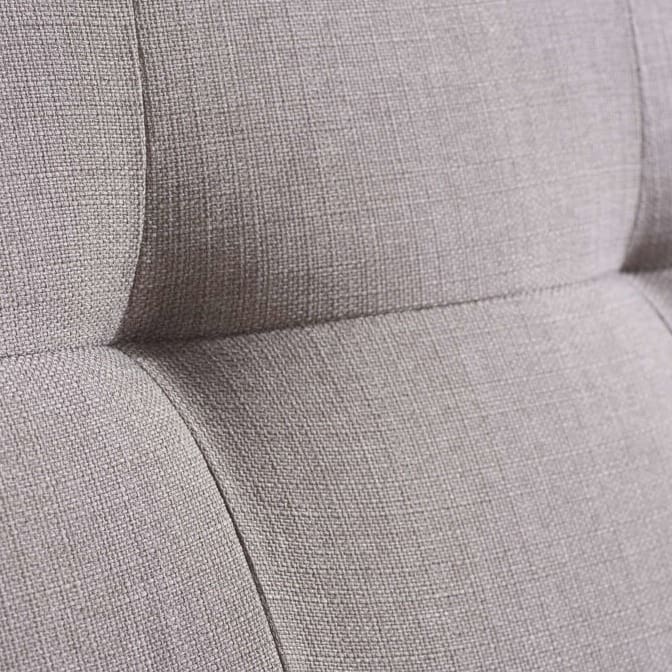Close up of a grey fabric sofa bed