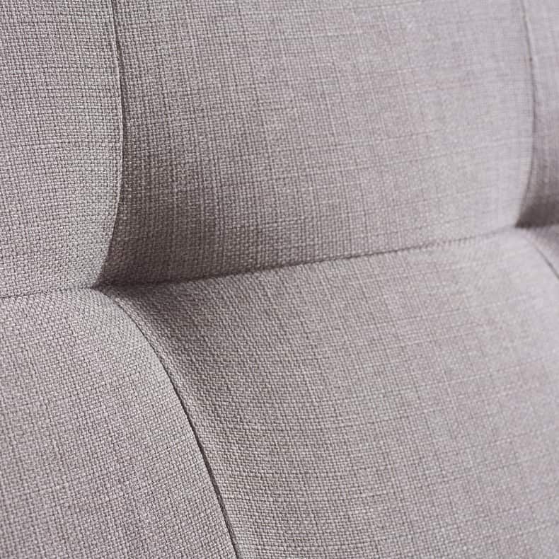 Close up of a grey fabric bed
