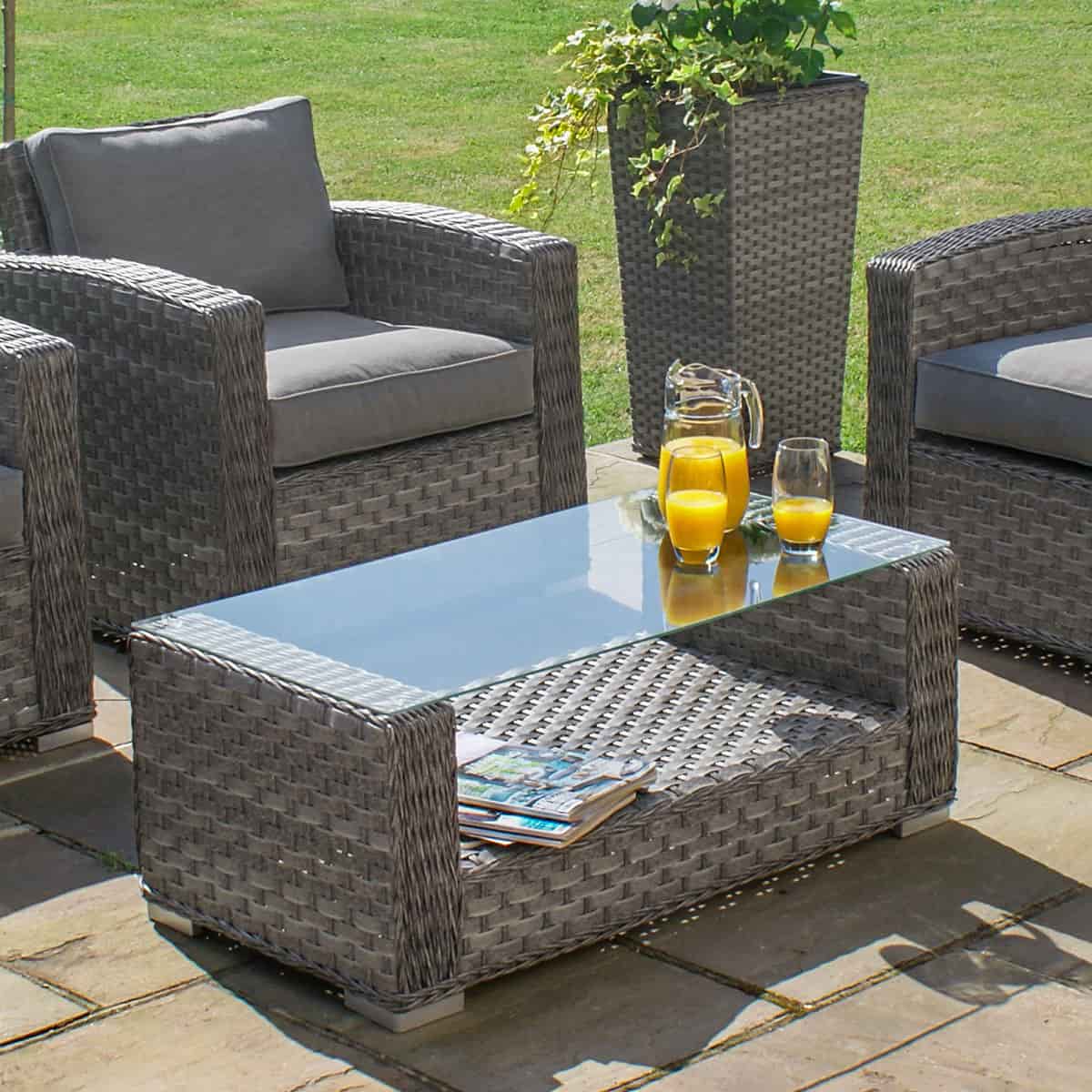 Grey rattan 2 seat sofa set with two armchairs and a matching coffee table with glass table top