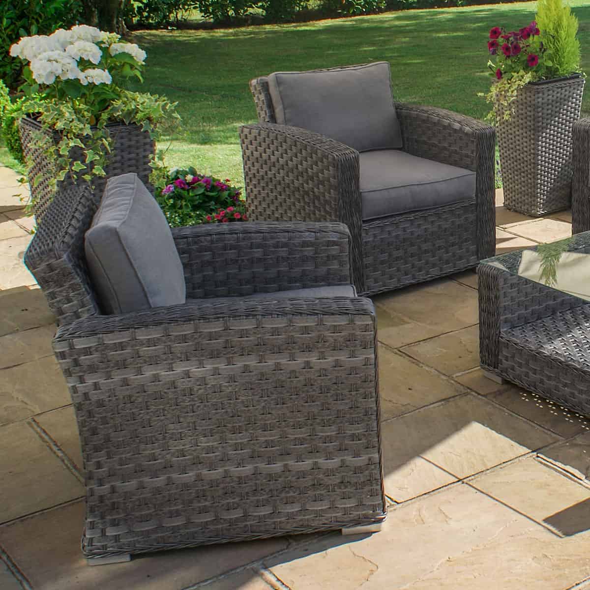 Grey rattan 3 seat sofa set with two chairs and a matching coffee table with glass table top