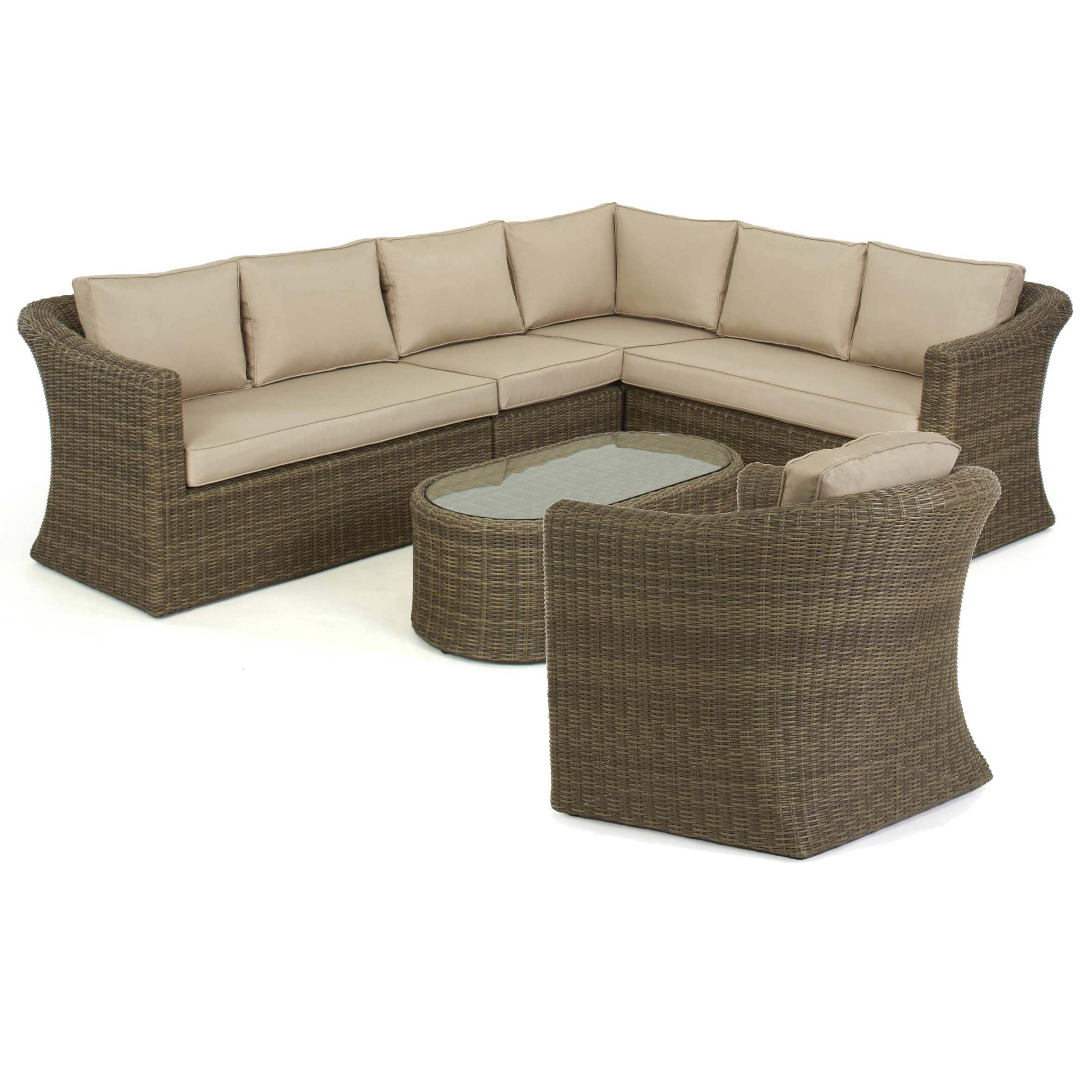 Natural coloured rattan corner sofa with matching armchair and oval coffee table.