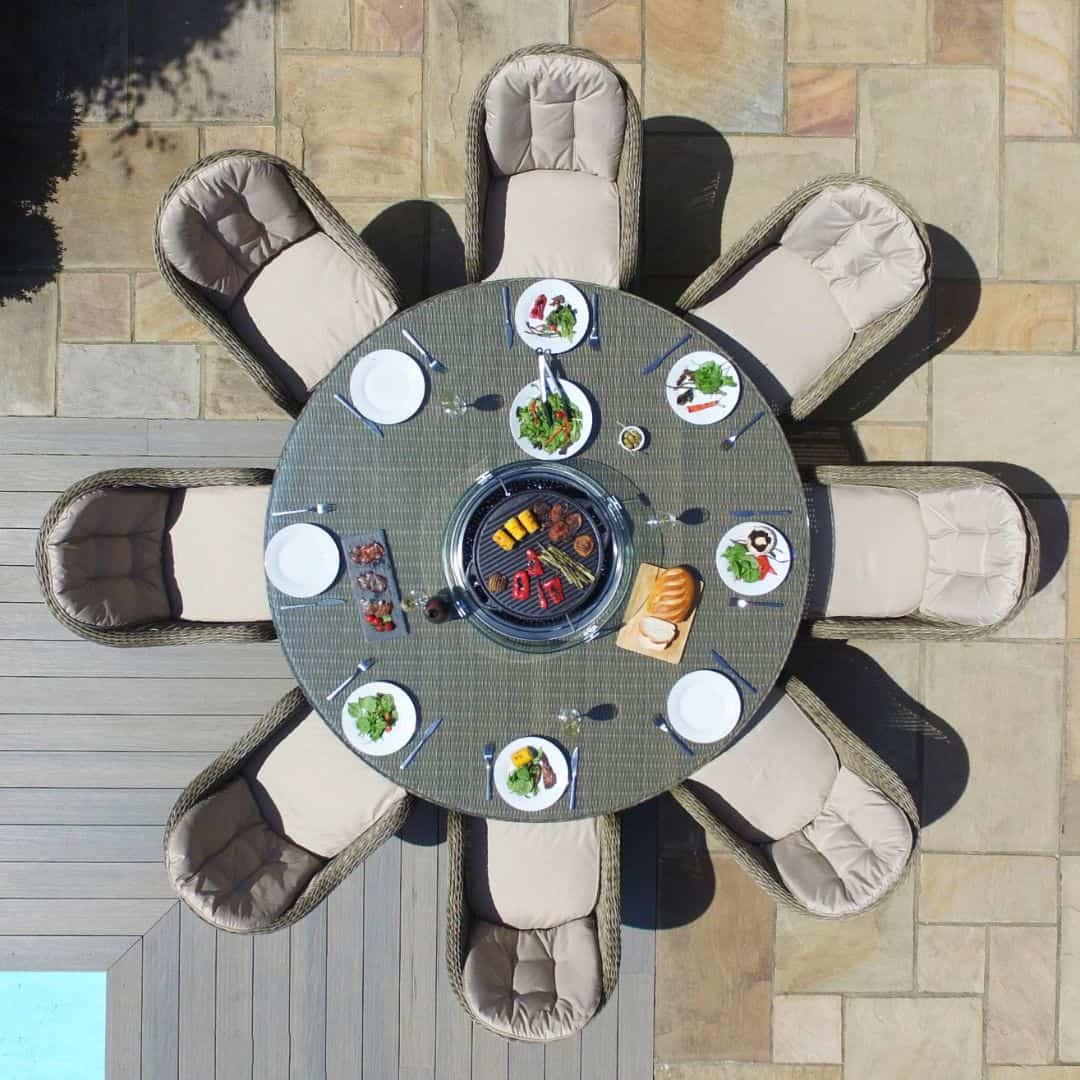 Overhead view of a natural coloured rattan 8 seat round dining set with fire pit table