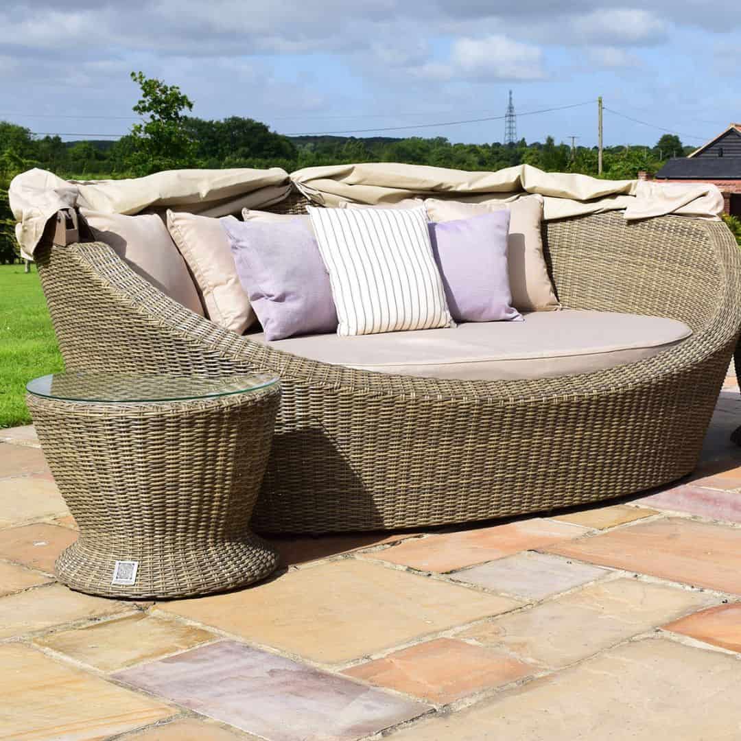 Natural coloured rattan daybed with retractable canvas hood and two matching side tables