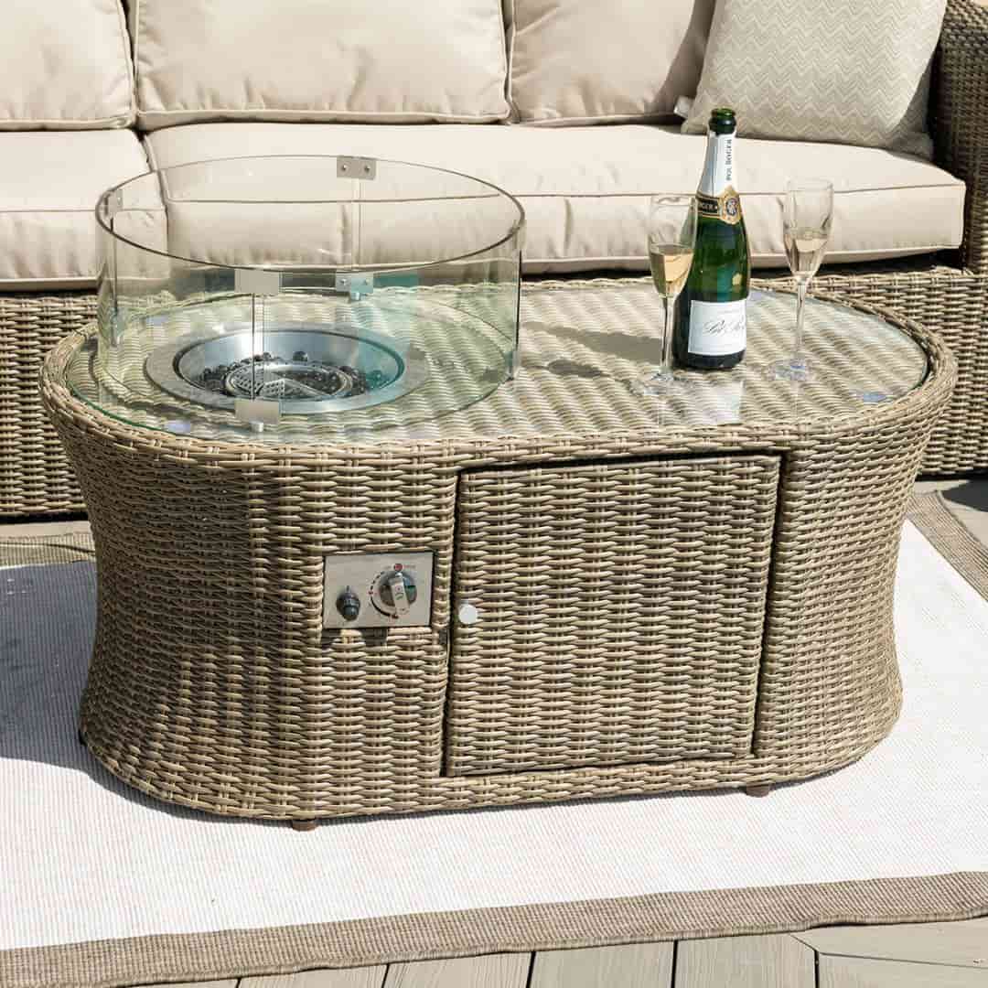 Natural coloured rattan oval fire pit coffee table.