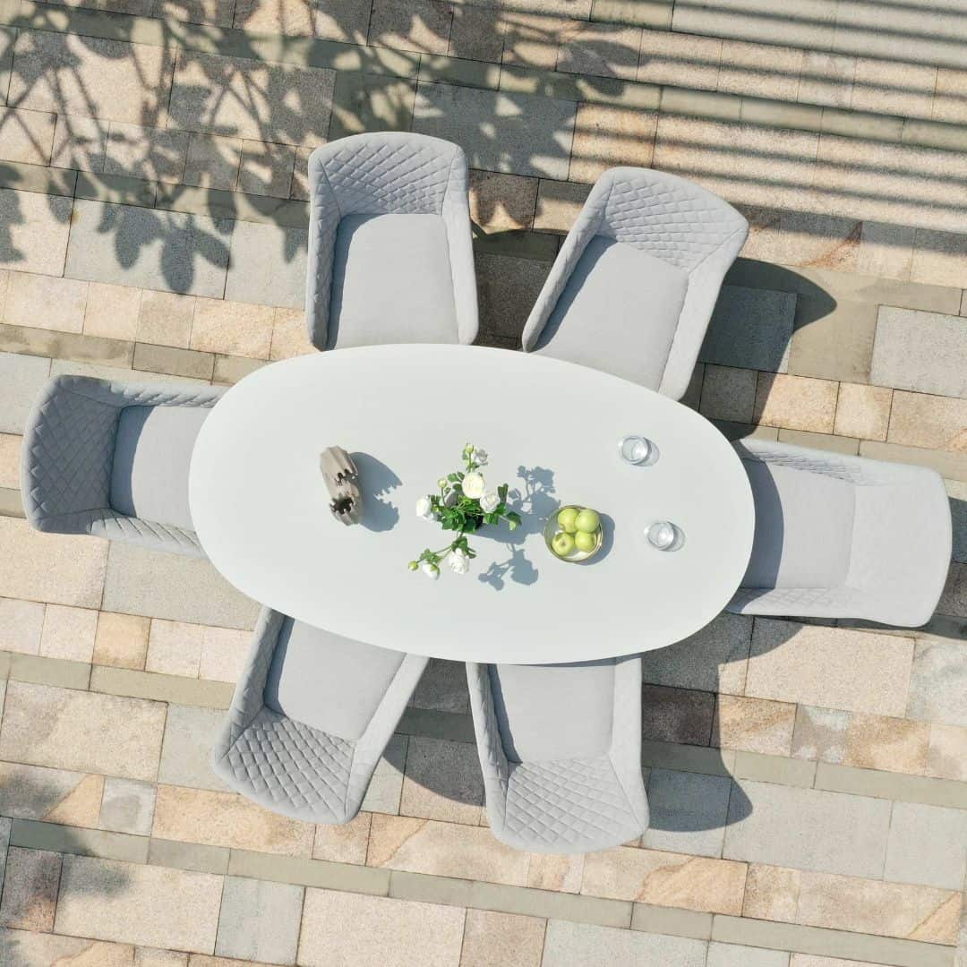 Overhead view of a 6 seat oval dining set with a white frame and light grey fabric dining chairs #colour_lead chine