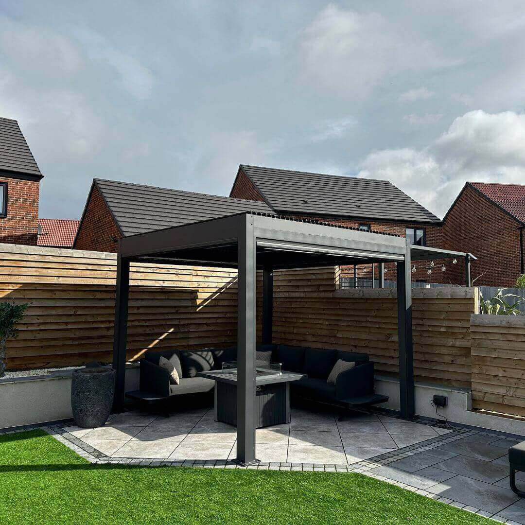 3m x 3m anthracite grey aluminium pergola with motorised louvred roof and privacy screens. LED lighting 