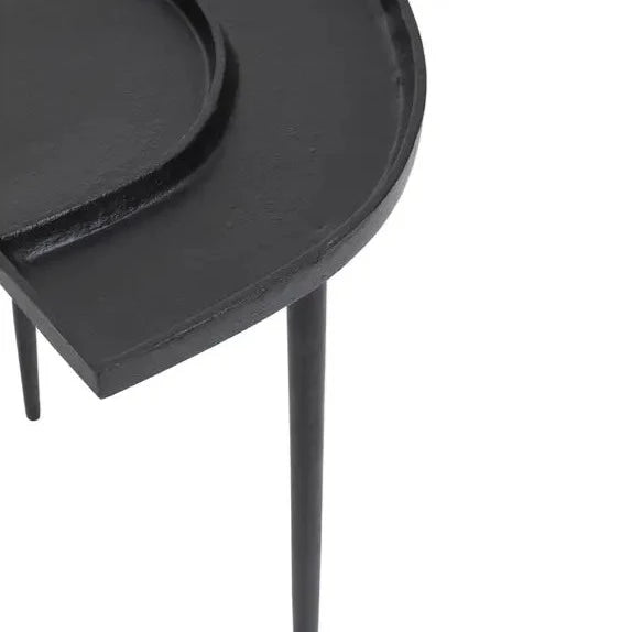 Close up of a black nickel side table. 