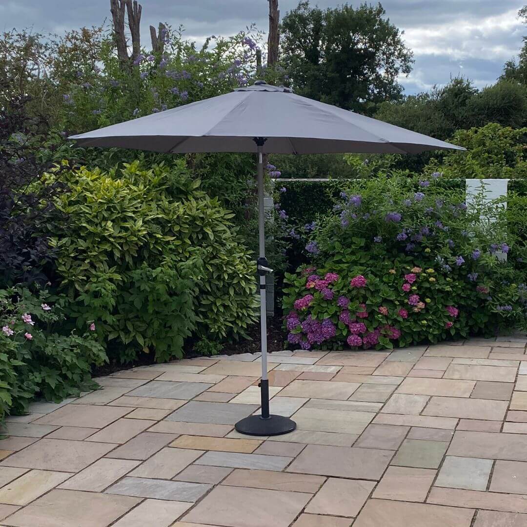 An open grey outdoor parasol.