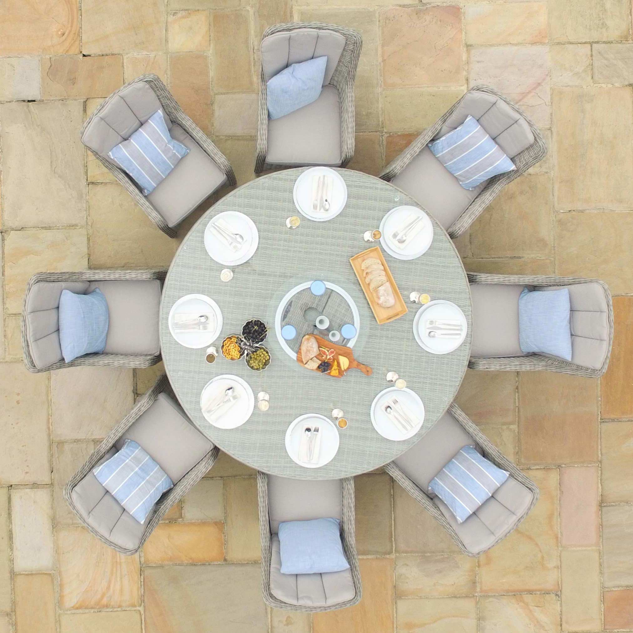 Overhead view of a light grey rattan 8 seat round ice bucket dining set with Venice chairs