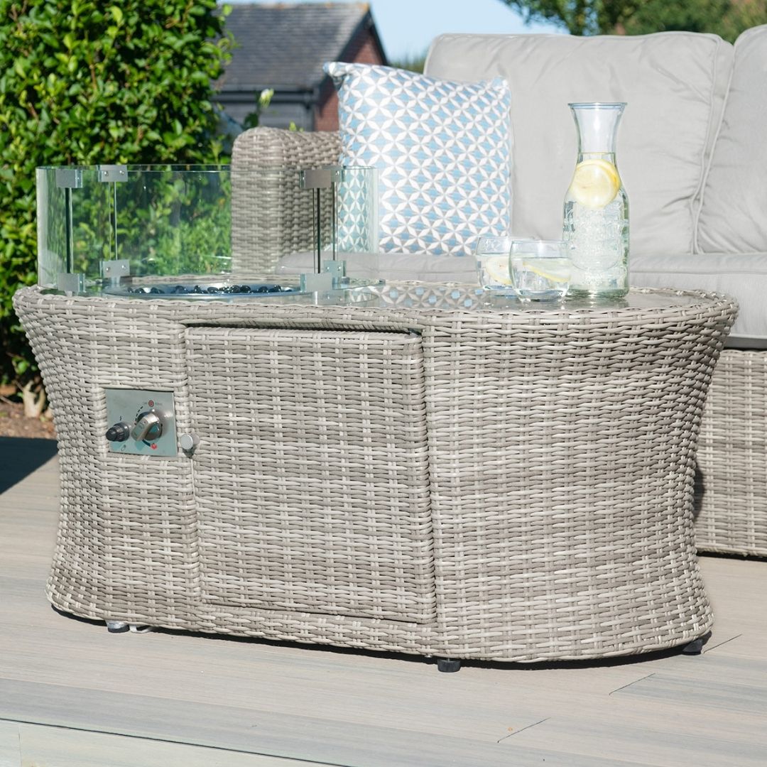 Light grey coloured rattan 2 seat sofa set with two armchairs and fire pit table