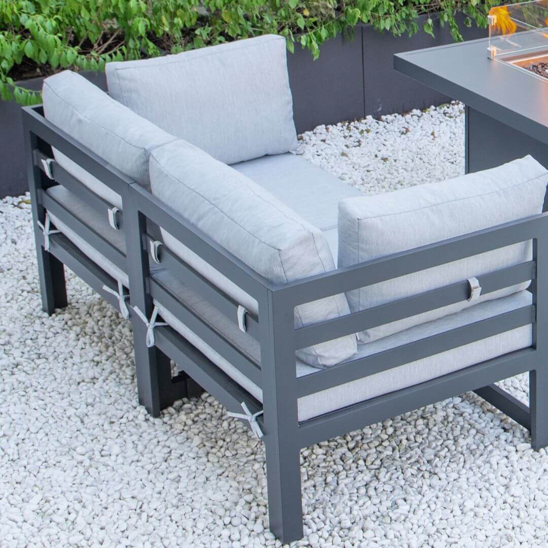 Close up of a grey aluminium 2 seat sofa with padded seat and back cushions.