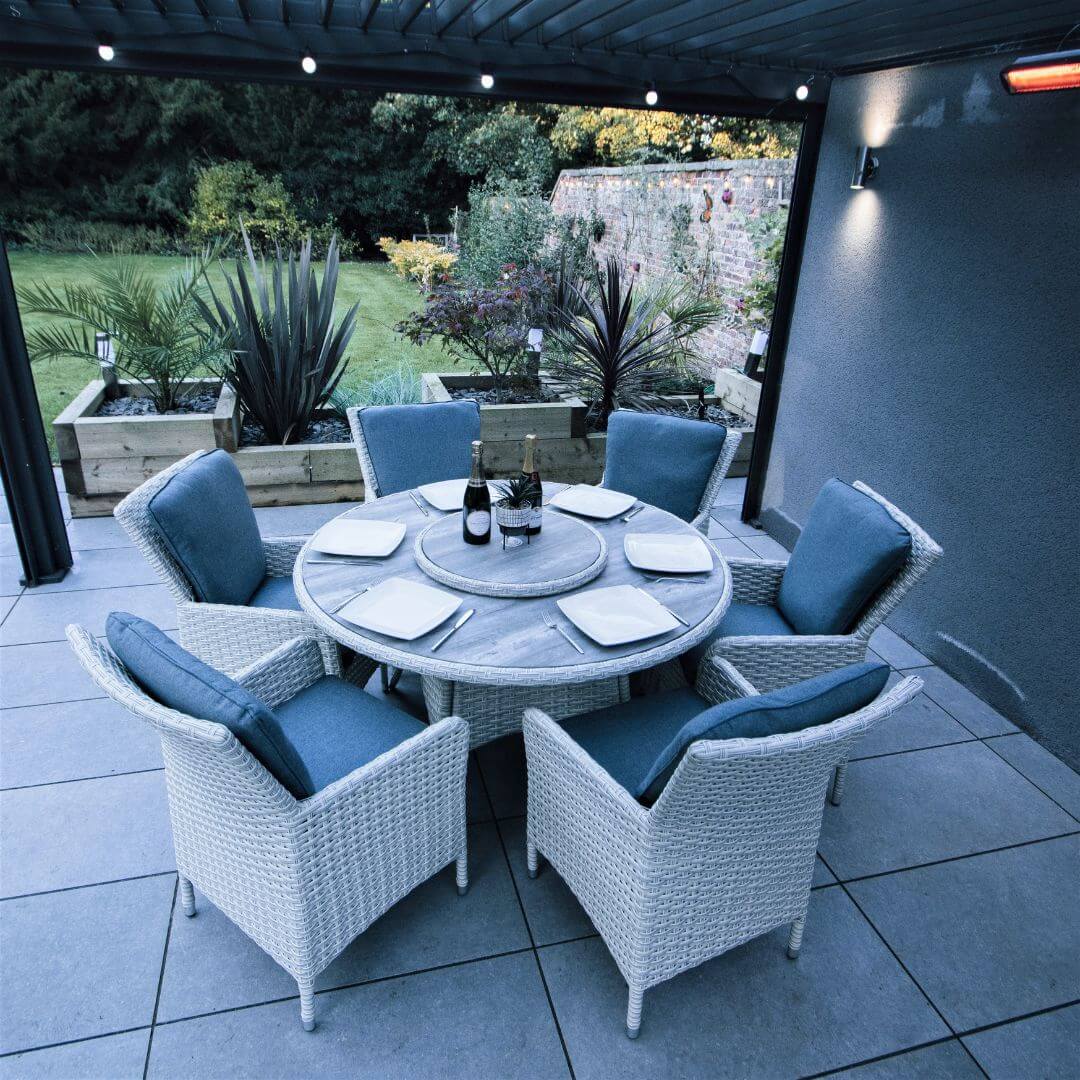 Light grey rattan 6 seat round dining set with ceramic printed glass table top and lazy susan.