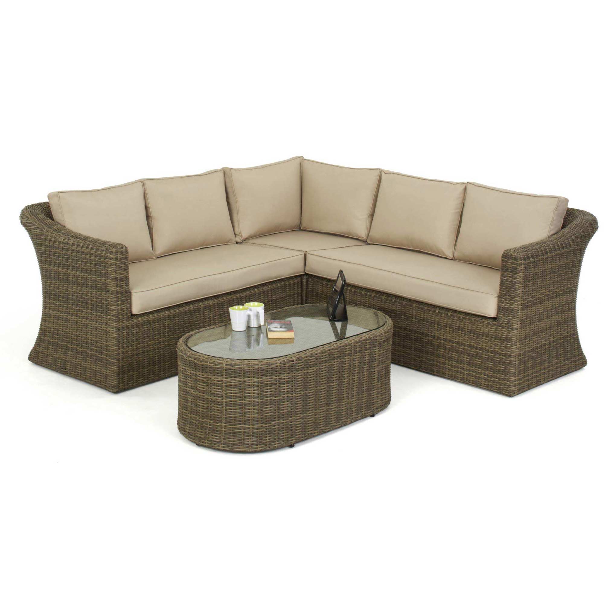 Natural coloured rattan corner sofa and matching oval coffee table.