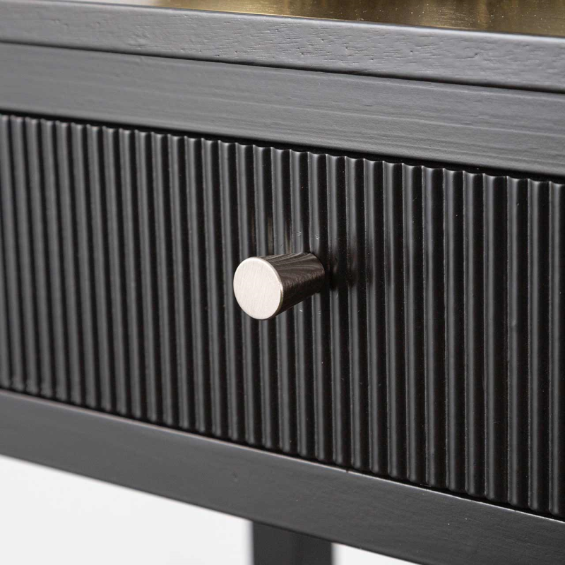 Close up of a black wood finish console table drawer with grooved design and metal handle.